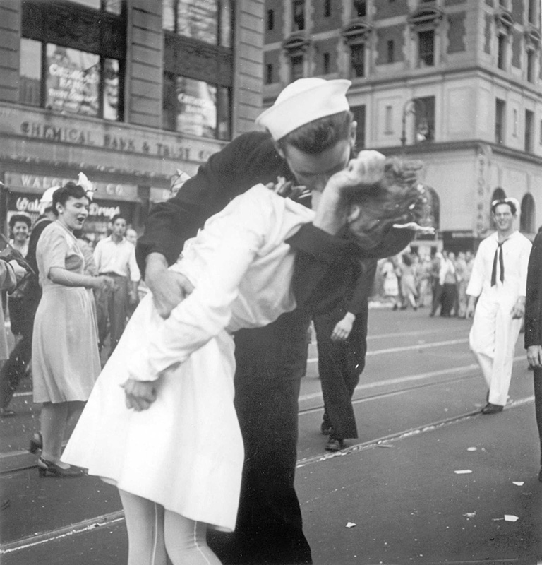 ADDS INFORMATION ABOUT PHOTOGRAPHER- FILE - In this Aug. 14, 1945 file photo provided by the U.S. Navy, a sailor and a woman kiss in New York's Times Square, as people celebrate the end of World War II. The ecstatic sailor shown kissing a woman in Times Square celebrating the end of World War II has died. George Mendonsa was 95. This image was taken by U.S. Navy photographer Victor Jorgensen. The photo is of the same moment that photographer Alfred Eisenstaedt captured and first published in Life magazine. (Victor Jorgensen/U.S. Navy, File)